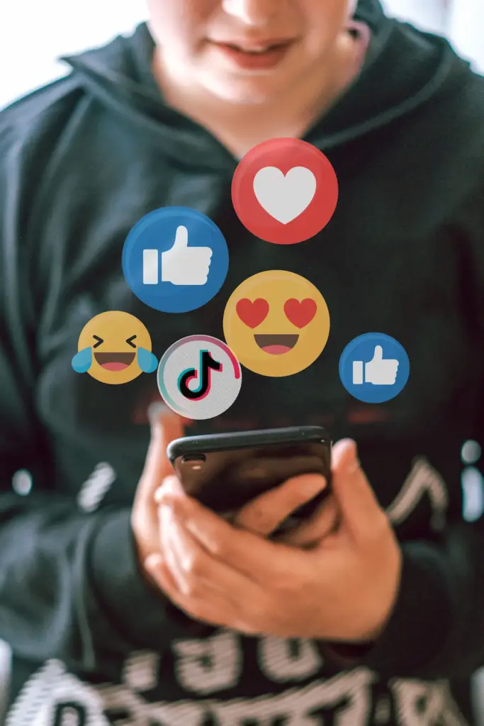 person using smart phone with social media likes and reactions showing social marketing engagment